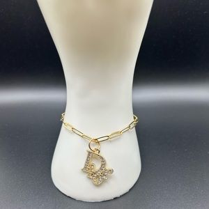 1 pre loved zipper pull charm on an 18kt gold plated sterl silver bracelet